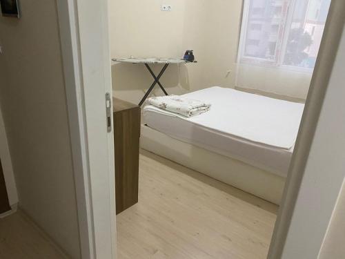 a small room with a bed and a window at Smart Apartment in Antalya