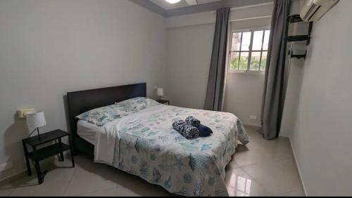 a bedroom with a bed with a stuffed animal on it at Las Palmeras by Graziano in Boca Chica