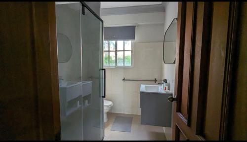 a bathroom with a toilet and a sink at Las Palmeras by Graziano in Boca Chica