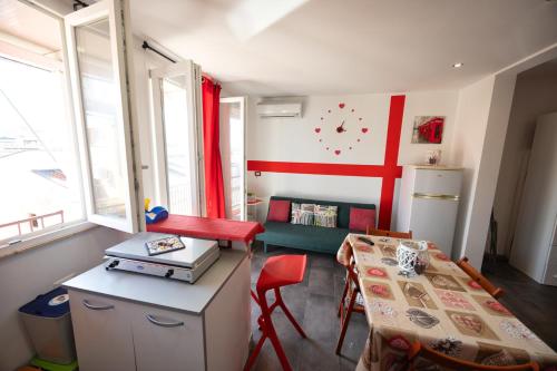 a small room with a table and a refrigerator at Disiu Case Vacanza in Balestrate