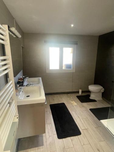 a bathroom with a sink and a toilet at La maison du Bas in Naours