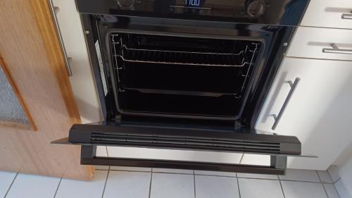 an oven is sitting on a shelf in a kitchen at Dorfstrasse 45 Sankt Annen in Sankt Annen