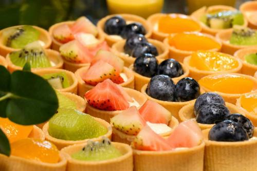a bunch of fruit appetizers in fruit cups at Four Points by Sheraton Singapore, Riverview in Singapore