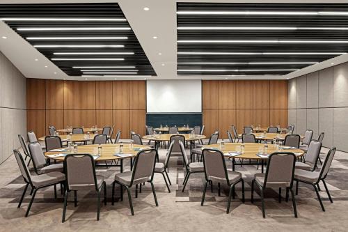 a conference room with tables and chairs and a screen at Four Points by Sheraton Istanbul Pendik in Istanbul
