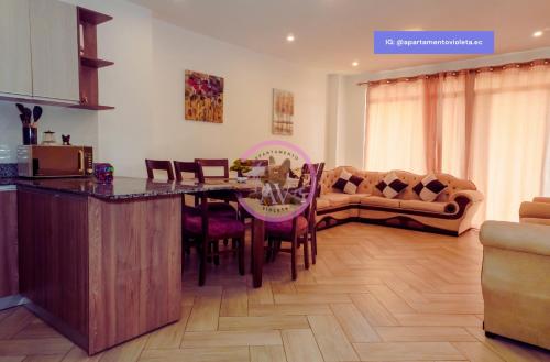 a kitchen and living room with a table and a couch at Apartamento Violeta con Impresionante Vista al Mar in Playas