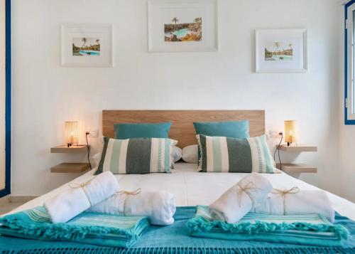 a bedroom with a large white bed with towels on it at Atlantic Soul in Playa Blanca