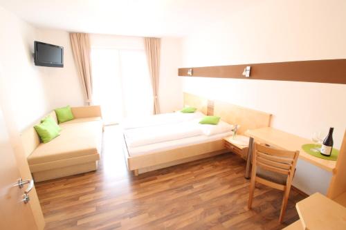 a living room with a couch and a table at Pension Joseph Haydn in Podersdorf am See