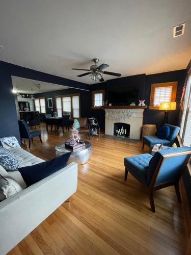 a living room with a couch and chairs and a fireplace at Get Kozy in Kenwood in Syracuse