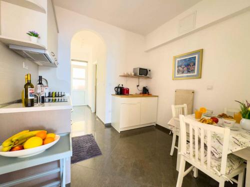 a kitchen with a bowl of fruit on a counter at Villa Leoni in Dubrovnik