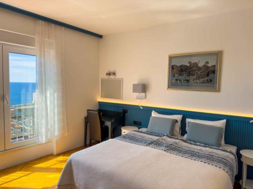 a bedroom with a bed and a large window at Villa Leoni in Dubrovnik