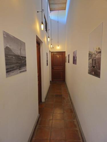 a hallway with a door and pictures on the walls at Nica Valley in Rivas