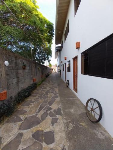 a corridor of a building with a stone walkway at Nica Valley in Rivas