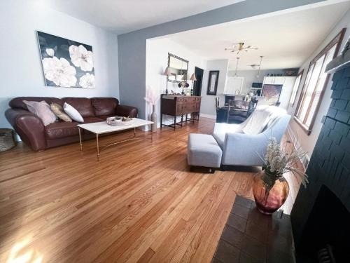a living room with a couch and a table at Come home to Kenwood Conveniently located Syracuse in Syracuse