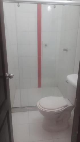 a bathroom with a toilet and a glass shower at Hotel Isla Capri in Mompos