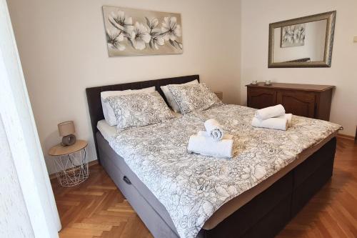a bedroom with a bed with two towels on it at Villa Rea in Malinska