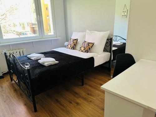 Una cama pequeña en una habitación con ventana. en Apartament pod Książem, en Wałbrzych