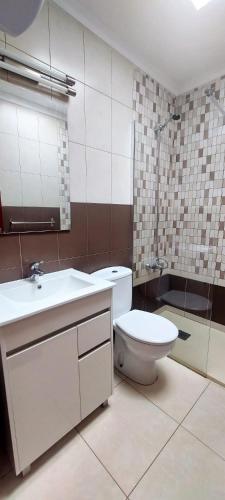 a bathroom with a toilet and a sink and a shower at Maspalomas J&O in Maspalomas
