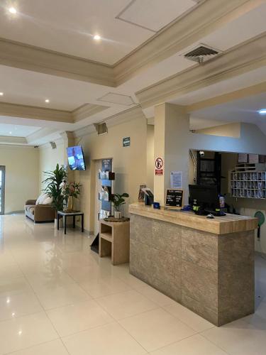 a lobby of a hospital with a reception counter at Hotel Plaza Express in Torreón