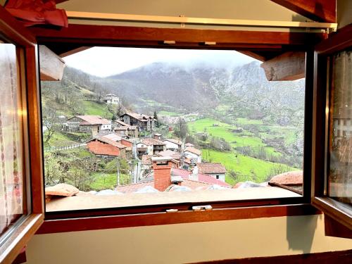 a view out of a window of a village at Viviendas Rurales El Cantón in Cucayo