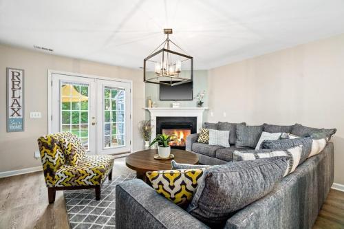 a living room with a couch and a fireplace at Cozy 2BR Retreat with BBQ, WIFI & Parking in Raleigh