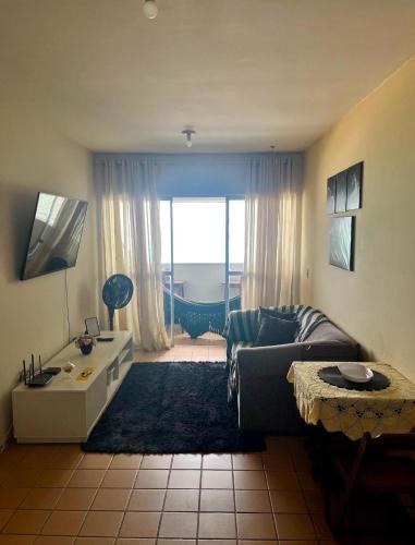 a living room with a couch and a table at Apartamento Vista-Mar in Maceió