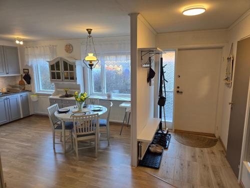a kitchen and dining room with a table and chairs at Blanka10 in Blankaholm