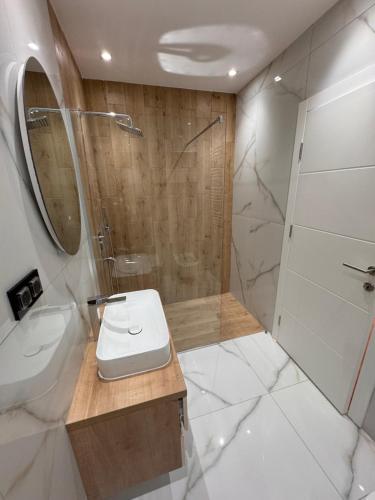 a bathroom with a shower and a toilet and a sink at Moon night in Niš