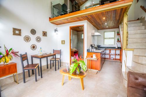 a kitchen and dining room with a table and chairs at Casitas Del Rio Riverfront Nature Lodge in Uvita