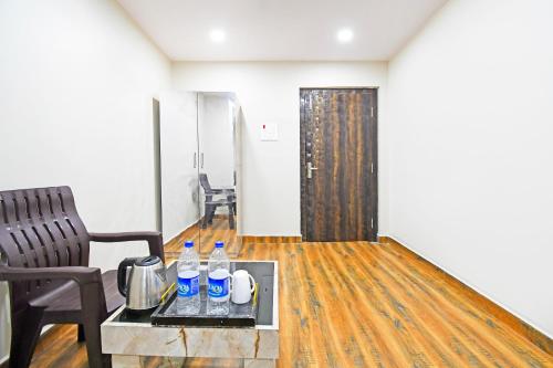 a room with a table with water bottles on it at Super Hotel O THE BLUE MOON in Dhanbād