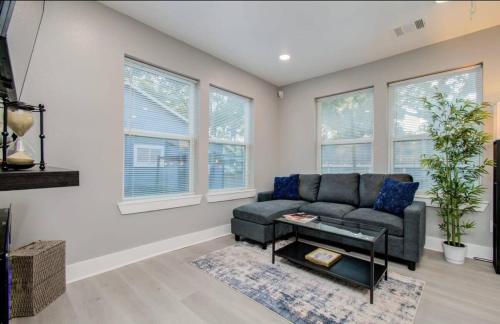 a living room with a couch and some windows at 2-Bedroom Townhouse in Houston in Houston