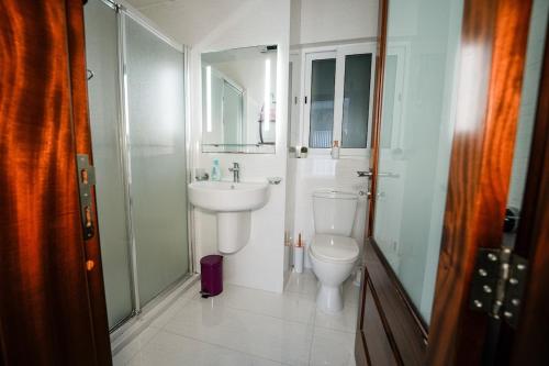 a bathroom with a toilet and a sink at Seaview flat in Mellieha's heart in Is-Sellum
