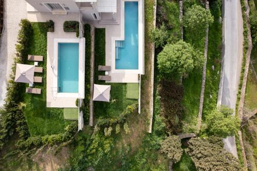 an aerial view of a house with two swimming pools at SuiteHome Villas with Private Pools by Explore Andros in Andros