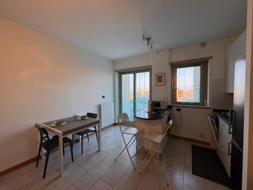 a kitchen with a table and a small table and chairs at Little Luxury Penthouse in Acilia