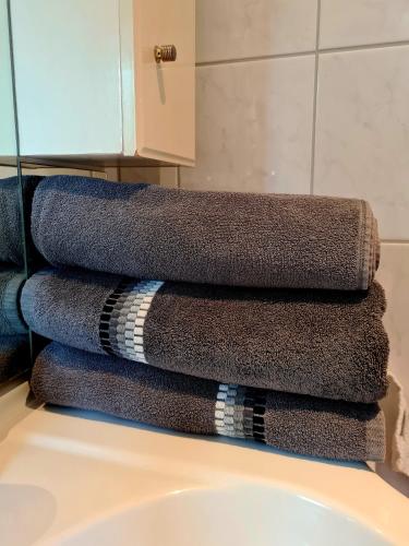 a pile of towels sitting on top of a bathroom sink at Kezara Living in Konz
