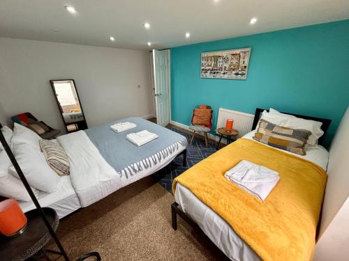 two beds in a room with blue walls at Seaside Chapel Escape Character Home Near Beach Sleep 5 in Great Yarmouth