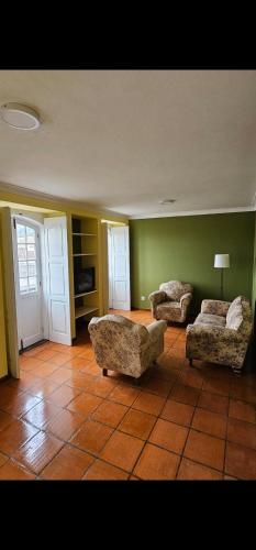 a living room with two chairs and a couch at Sé House View in Angra do Heroísmo