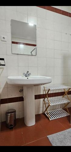 a bathroom with a white sink and a mirror at Sé House View in Angra do Heroísmo
