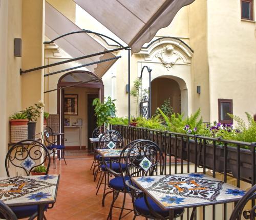 a patio with tables and chairs and a building at Maison Tofani in Sorrento