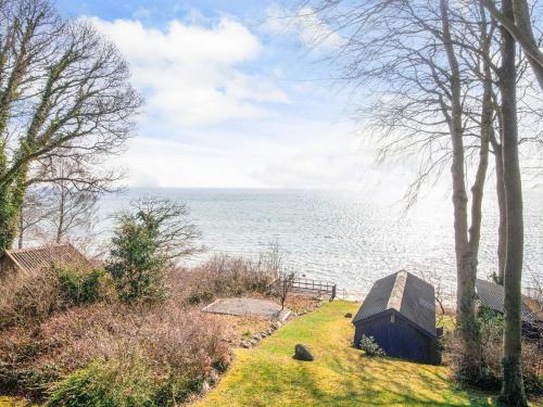 a house on the shore of a body of water at 6 person holiday home in Bjert-By Traum in Bjert Strand