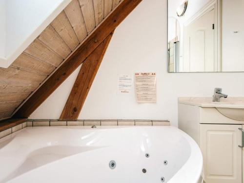 a bathroom with a white tub and a sink at 4 person holiday home in Blåvand in Blåvand