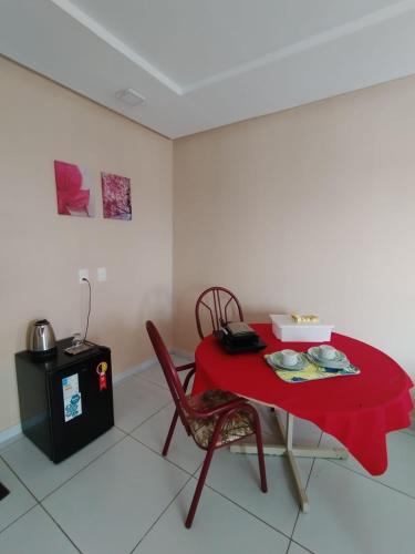 a red table with a red table cloth on it at Kitnet 2 com varanda in Mossoró