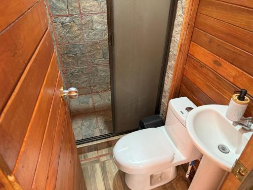 a bathroom with a toilet and a sink at Colonial Guanacaste Villas in Guanacaste