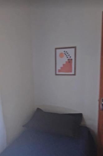 a white room with a picture on the wall at CASA COLONIAL Ilha da Croa in Barra de Santo Antônio