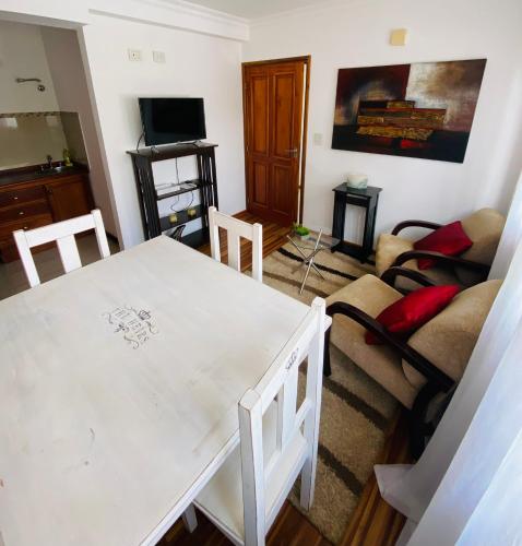 a living room with a white table and a couch at THE HEIRS Departamentos in Posadas