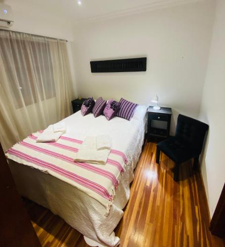a bedroom with a large bed with towels on it at THE HEIRS Departamentos in Posadas