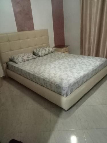 a bed sitting in a bedroom with a mattressvisor at Saidia palace in Saïdia