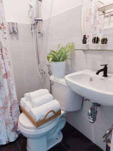 a bathroom with a toilet and a sink at De Richness in Tagbilaran City