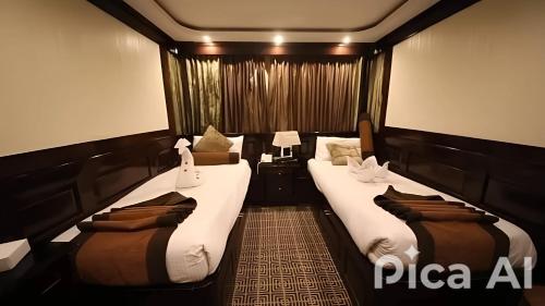 two beds in a small room with at الباخرة نايل كروز in Cairo