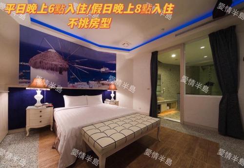 a bedroom with a bed with a poster of a ship at AmanCity Motel in Pingtung City