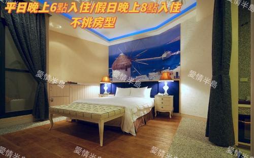 a bedroom with a bed and a painting of a ship at AmanCity Motel in Pingtung City